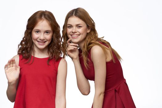 Mom and daughter red dress hug family joy friendship. High quality photo