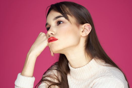 Woman with red lips bright makeup white blouse long hair pink background. High quality photo