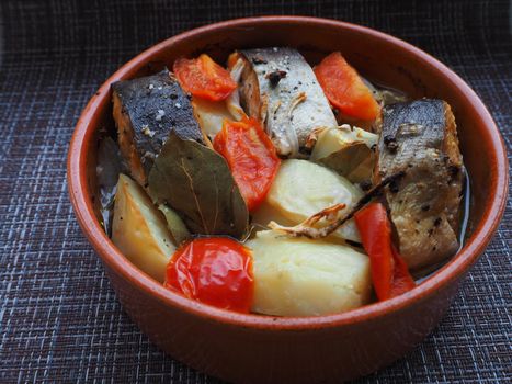 A dish of fish with vegetables baked in the oven. Close-up.