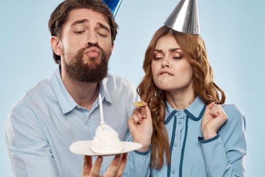 Birthday corporate young man and woman with cake on isolated background disco party. High quality photo