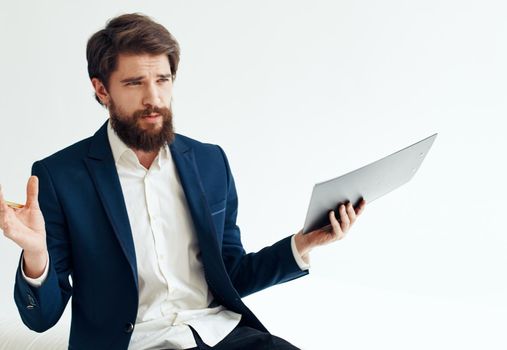 Business man gesturing with his hands in a classic suit Sitting on a sofa indoors. High quality photo