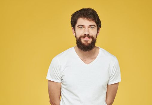 portrait of a man in a white t-shirt on a yellow background cropped view Copy Space. High quality photo