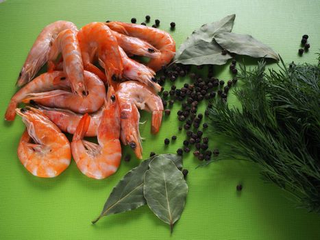 Large prawns with spices and spaghetti. Prawns with dill and pepper close-up. Bright background.