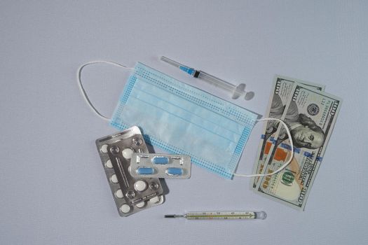 Banknotes, the US dollar, and medicines. The concept of the cost of medicines. High quality photo