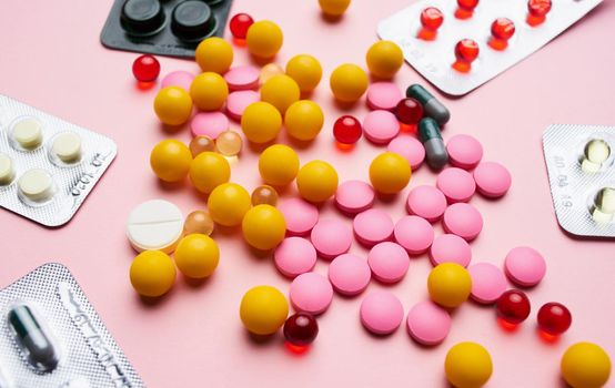 medicine pills vitamins first aid kit pink background. High quality photo