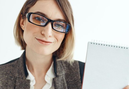 Portrait of a business woman in a suit with documents in hands on a light background. High quality photo