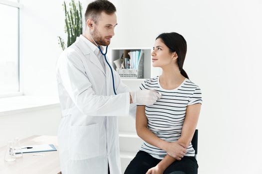 a doctor with a stethoscope examines a patient in a hospital. High quality photo