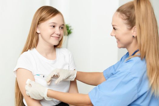 woman doctor giving a child a girl an injection in the arm. High quality photo
