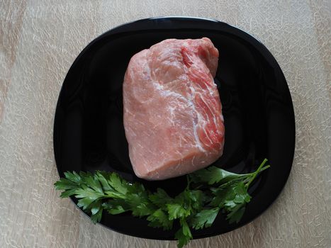 Fresh raw meat. A large piece of pork for baking. Close-up. Horizontal image.