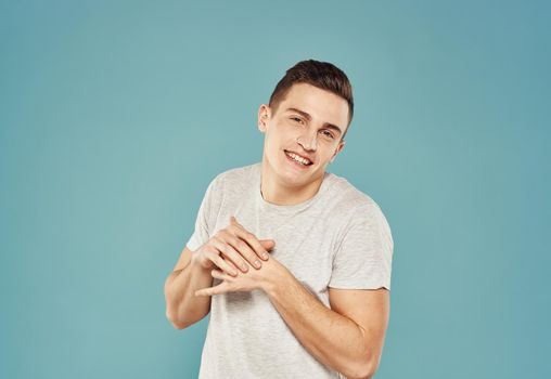 Handsome man in white t-shirt studio lifestyle blue background. High quality photo