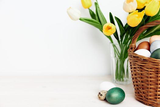 church holiday easter eggs and yellow tulips on the table. High quality photo