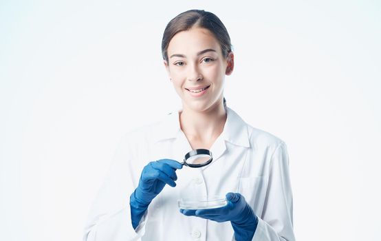 woman doctor in blue gloves and in a medical gown vaccine chemical element laboratory. High quality photo