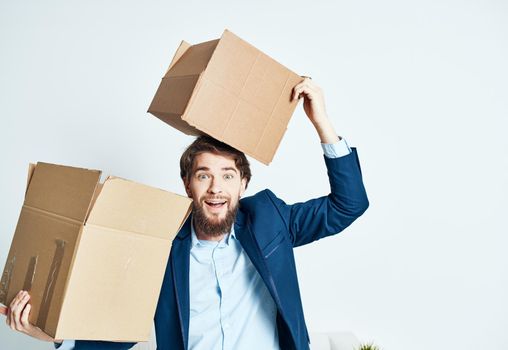 A man with boxes while a suit is moving unpacking. High quality photo