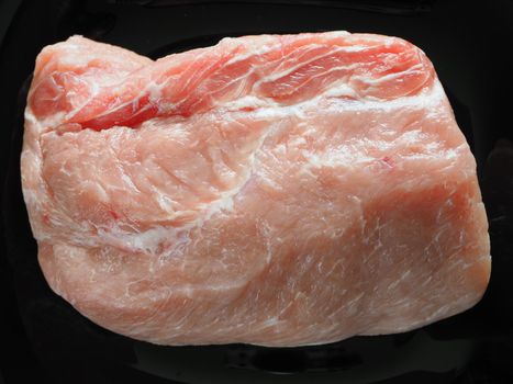 Fresh raw meat. A large piece of pork for baking. Close-up. Horizontal image.