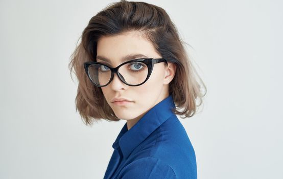woman in a blue shirt and glasses emotions manager. High quality photo