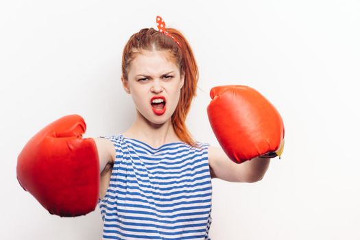 boxing woman in red gloves striped t-shirt makeup hairstyle. High quality photo