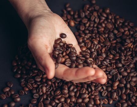coffee bean in hand preparing beverage morning close-up energy. High quality photo