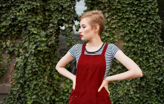 cute blonde short hair walk in the park Red sundress. High quality photo