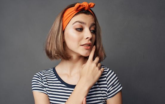 pretty woman in striped t-shirt bandage orange on her head fashion emotions. High quality photo