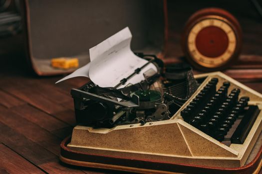 vintage typewriter for printing white sheet of paper wooden background retro invention. High quality photo