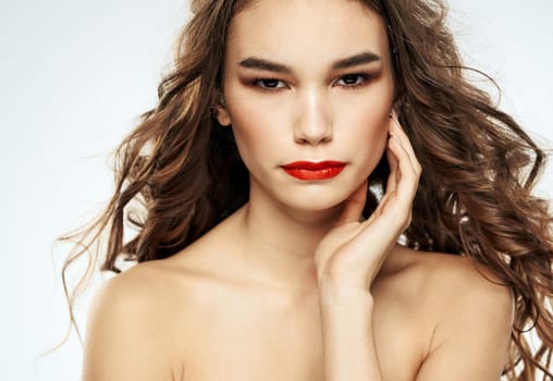 Woman model red lips eyeshadows bared shoulders portrait cropped view. High quality photo