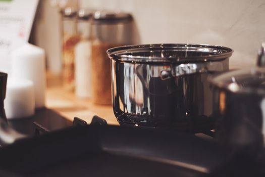 Aluminium pot on a kitchen stove, cookware and cooking concept