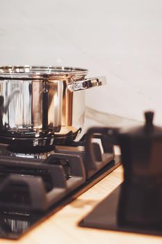 Aluminium pot on a kitchen stove, cookware and cooking concept