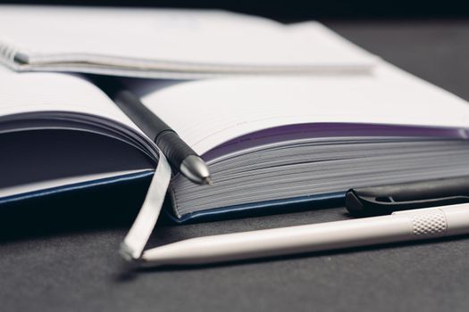 notebook books pens documents workplace office gray background. High quality photo