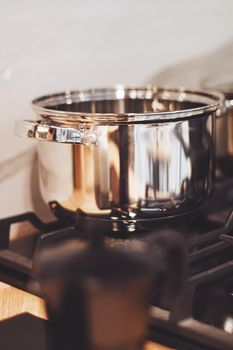 Aluminium pot on a kitchen stove, cookware and cooking concept