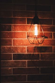 Pendant industrial lamps in loft interior with dark brick walls, modern design and home decor concept