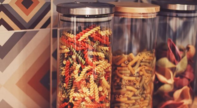 Pasta in dry food storage containers in the kitchen, pantry organisation and home decor idea