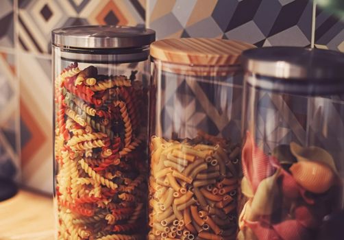 Pasta in dry food storage containers in the kitchen, pantry organisation and home decor idea