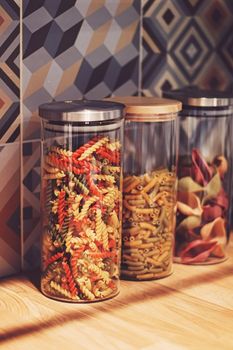 Pasta in dry food storage containers in the kitchen, pantry organisation and home decor idea