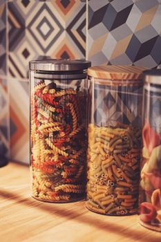 Pasta in dry food storage containers in the kitchen, pantry organisation and home decor idea