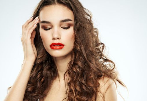 Beautiful woman red lips with eyeshadow and curly hair. High quality photo