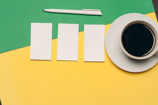 business cards on a bright background and ballpoint pen coffee cup top view. High quality photo