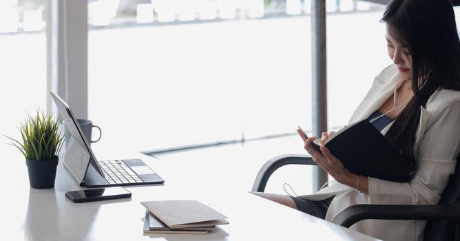 Businesswoman with earbuds for video conference for protection covid-19.woman using tablet webinar video course at home office.