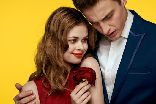 Man and woman date rose luxury yellow background. High quality photo