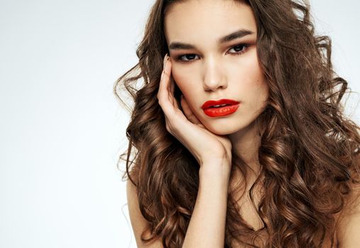 Portrait of a beautiful woman with red lips and curly hair at the barbershop. High quality photo