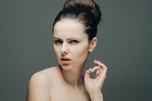 pretty brunette emotions nude shoulder hand on face luxury. High quality photo