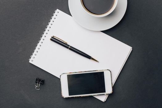 work desk notepad with pen drink cup phone technology. High quality photo