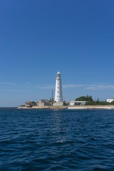 Marine landscape with views of the Cape Tarhankut and the white lighthouse against the sky. Travelling to Crimea.