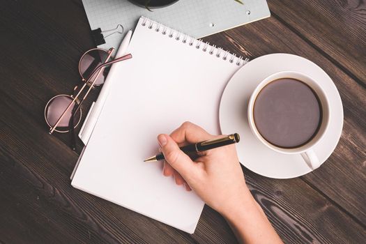 notepads ballpoint pen on table coffee cup potted flower office work freelancer. High quality photo