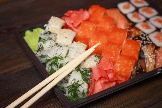 seafood sushi rolls wooden sticks japanese tradition ginger wasabi. High quality photo