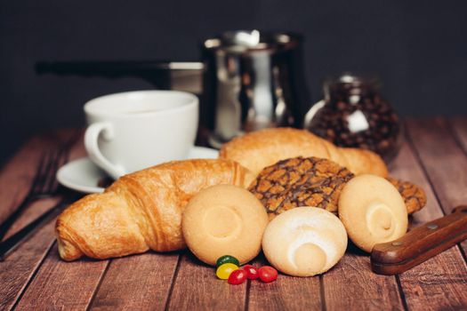sweets for tea croissants cookies on a wooden table. High quality photo