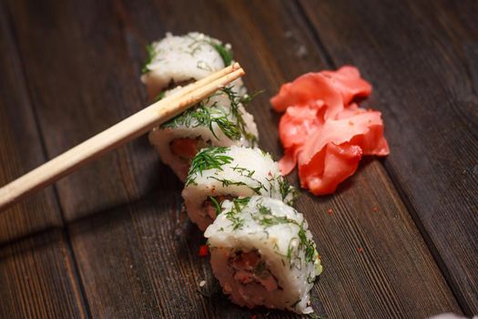 rolls red ginger food delivery japanese restaurant gourmet wooden table. High quality photo