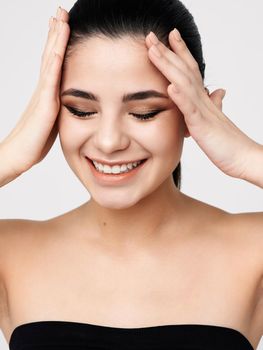 brunette with bare shoulders closed eyes cosmetics glamor. High quality photo