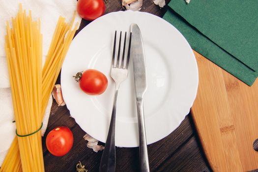 plate cooking cherry tomatoes and spaghetti italian. High quality photo