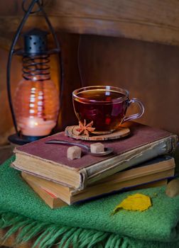 tea cup, green plaid, books on a chair. Home interior vintage dec up withor