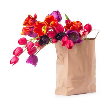 colorful tulips in a paper bag on a white background